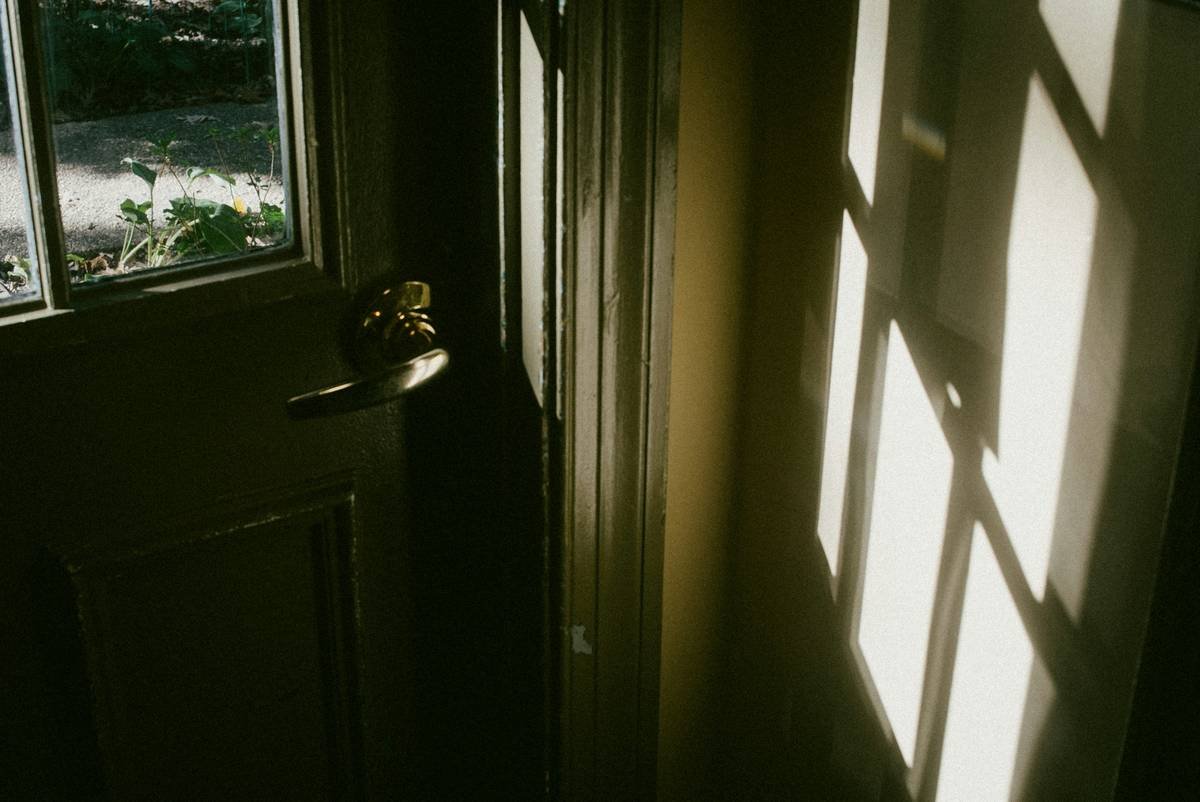 Heavy-duty storm doors with pet access installed on a coastal home
